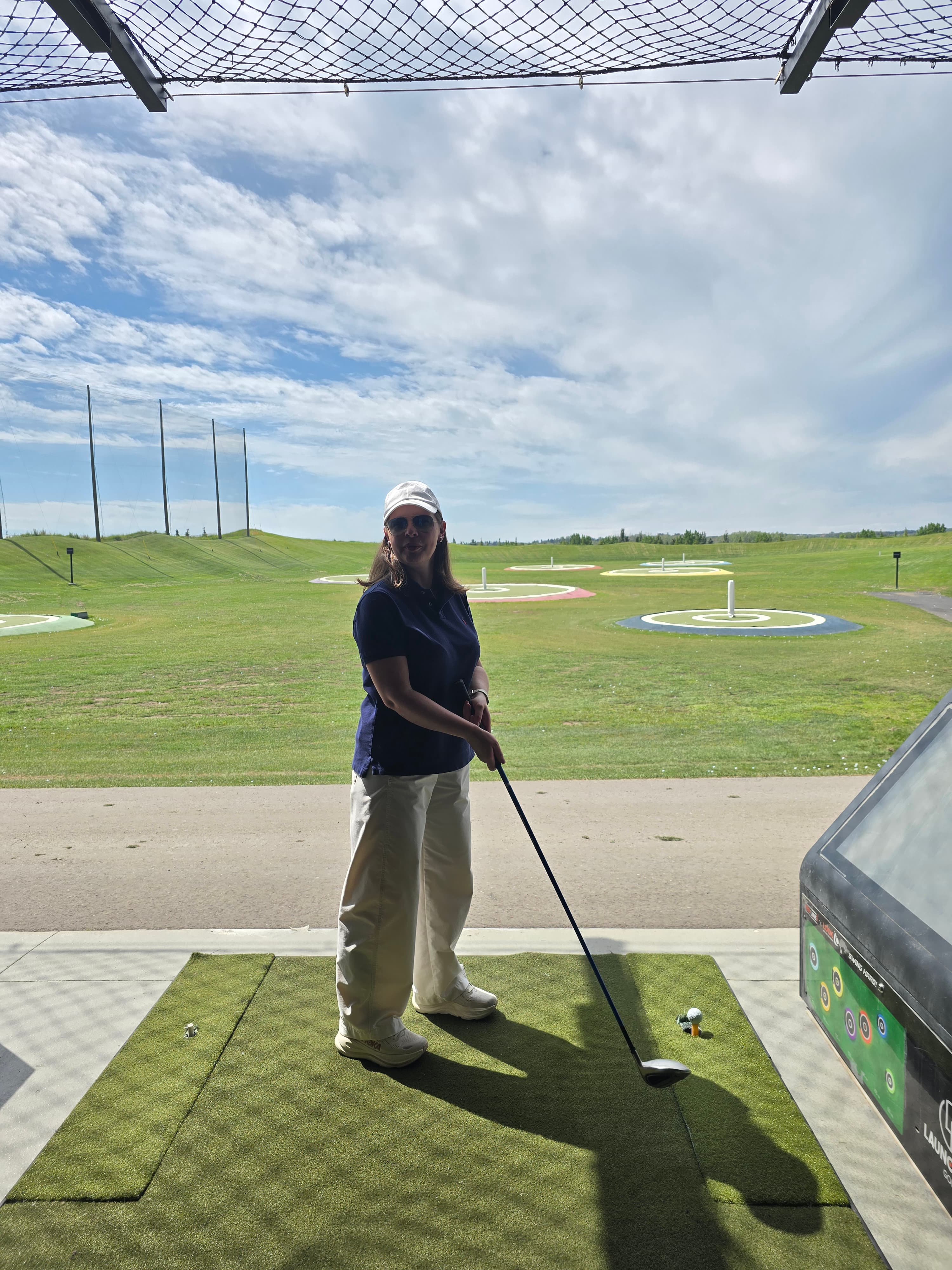 Iryna playing golf at the C21 Bravo Realty event