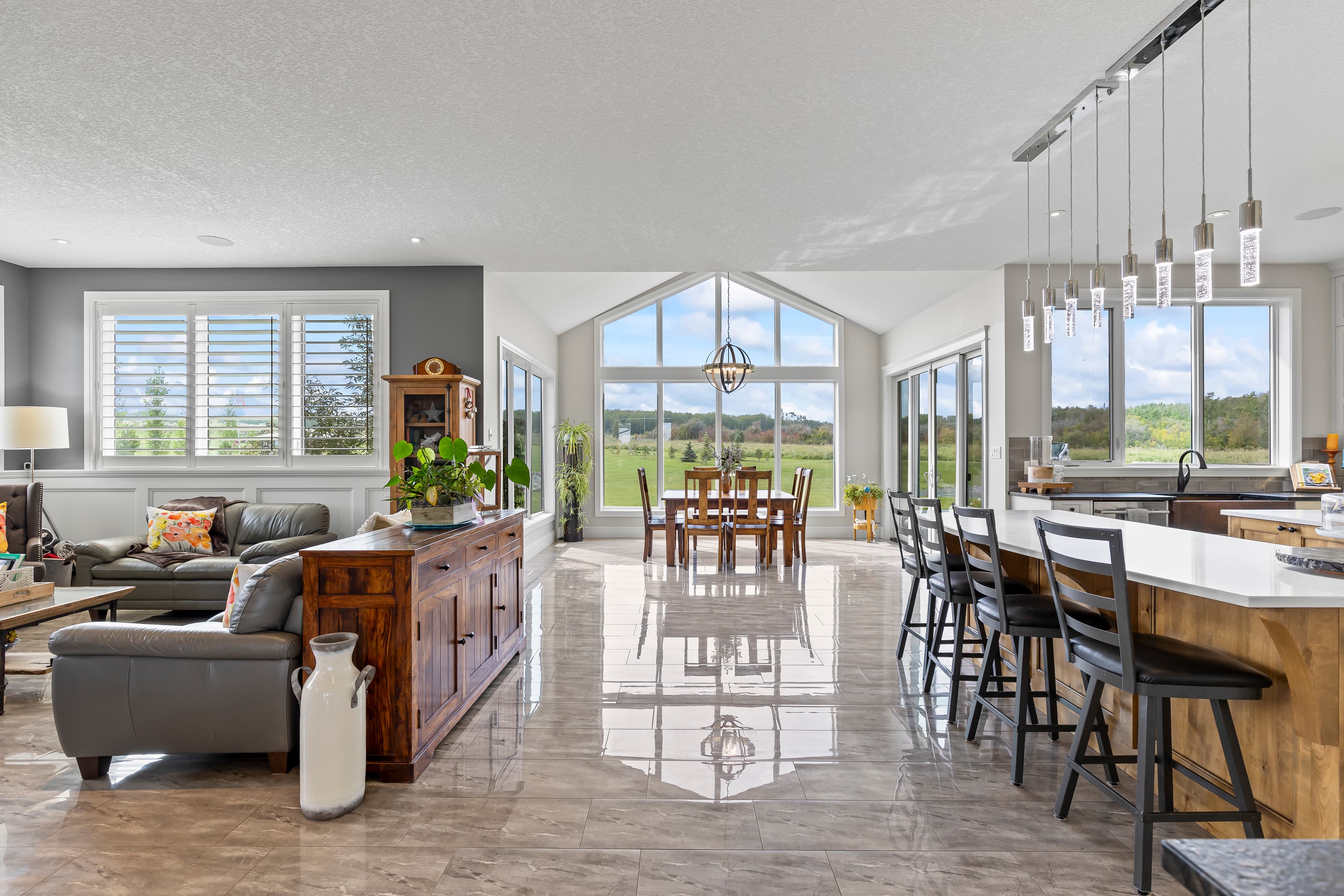 Dining area with table and scenic view in a Calgary luxury home photographed for a real estate listing by Photos 4 Real Estate