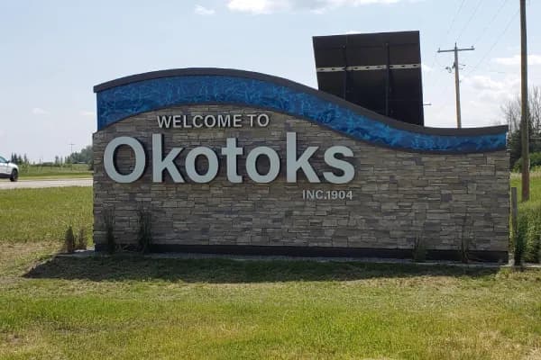 Real estate photography service area card for Okotoks family homes near Calgary