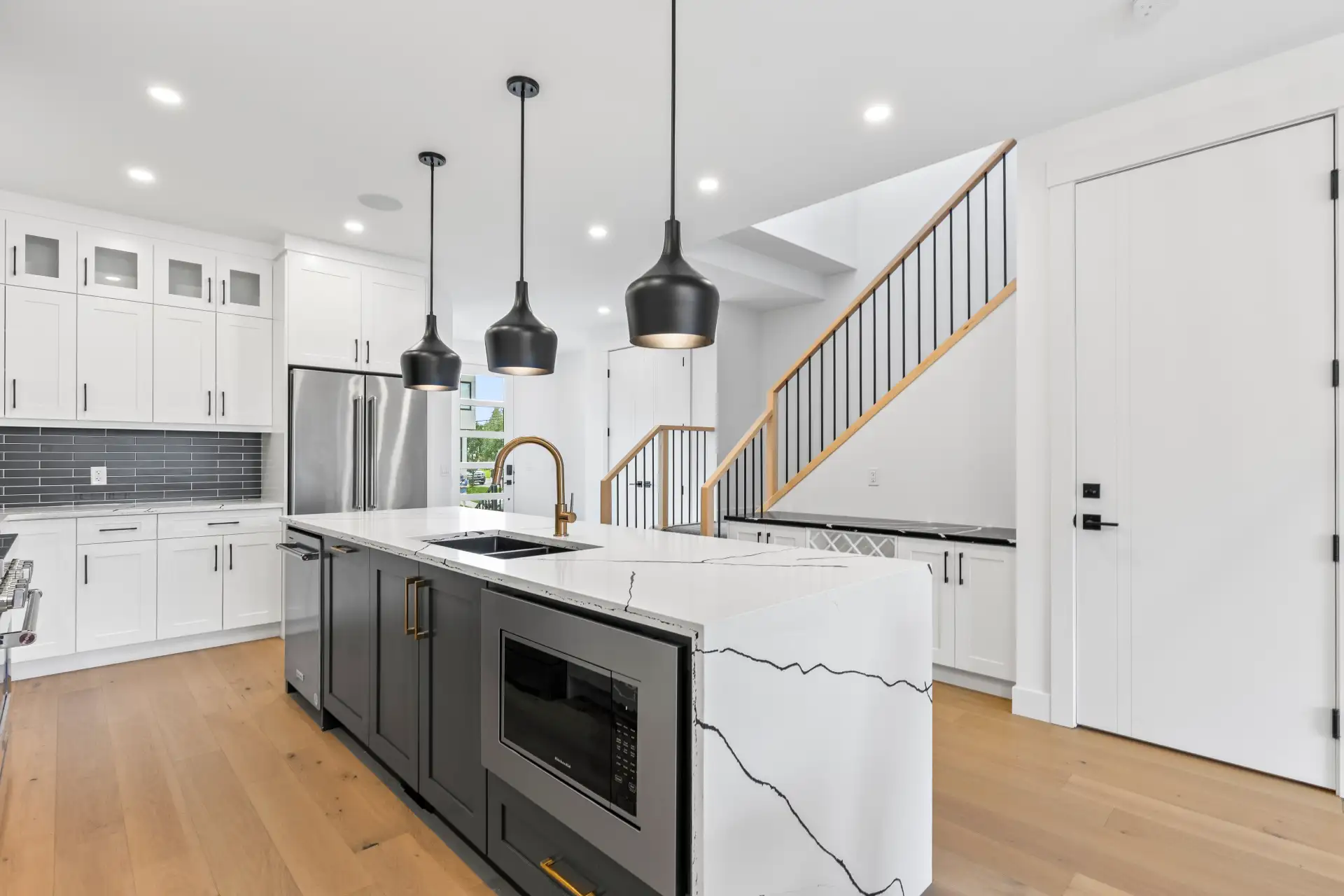 Professional real estate photography of a Calgary kitchen with quartz countertops by Photos 4 Real Estate