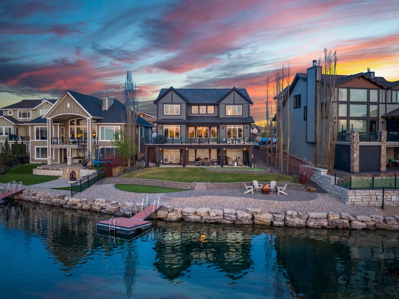 Lakefront Auburn Bay luxury home photographed at twilight for a Calgary real estate listing by Photos 4 Real Estate