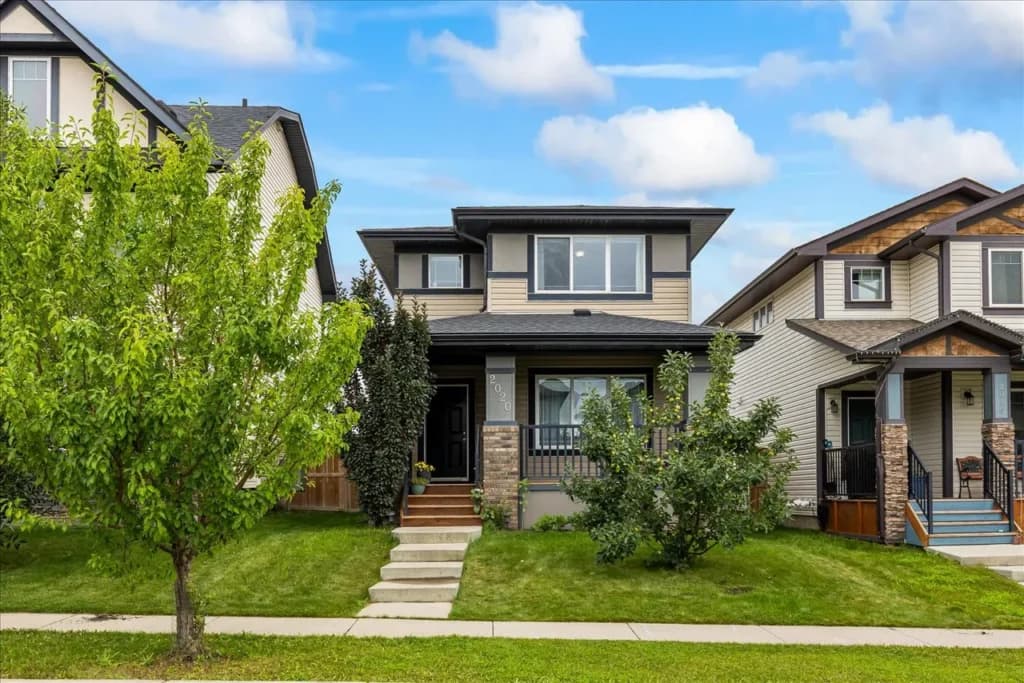 Bright interior real estate photo of an Airdrie home showing an open living space