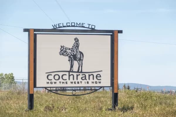 Exterior real estate photo of a Cochrane home with foothills character by Photos 4 Real Estate