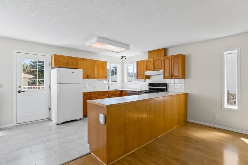 Kitchen real estate photo from a High River listing showing bright finishes and open layout