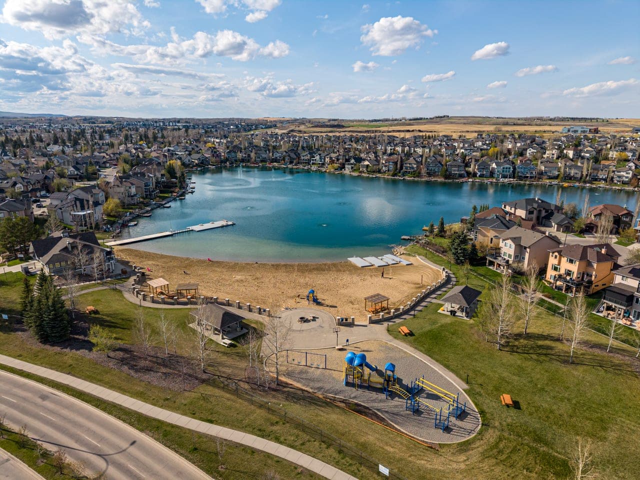 Drone view of an Okotoks lake community and surrounding homes for real estate marketing