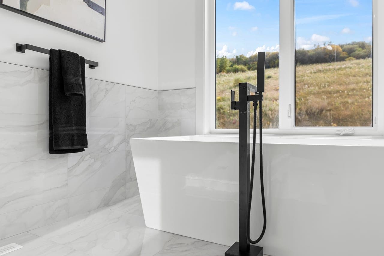 Style Shot of a bathtub and large window for a Calgary real estate listing